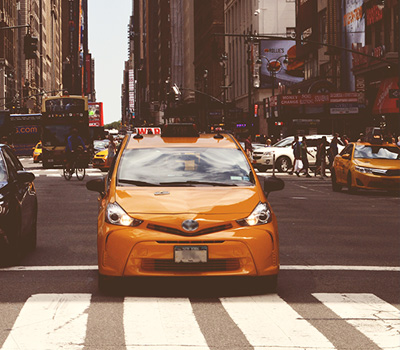 Yellow Uber Taxi Standing in Red Light in New York City
