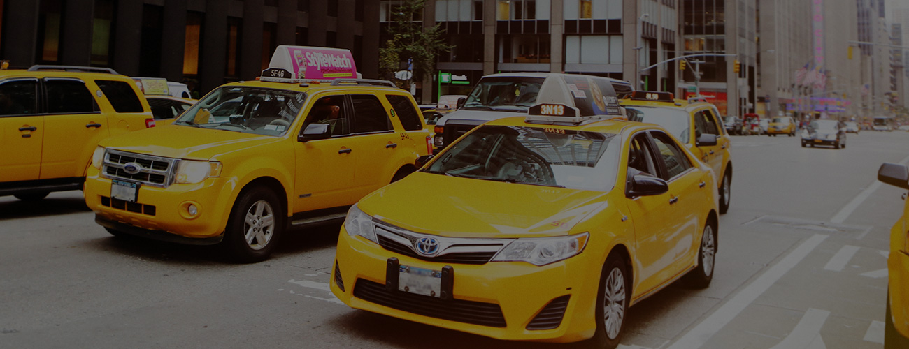 Many Yellow Rideshare Taxis in New York City Street